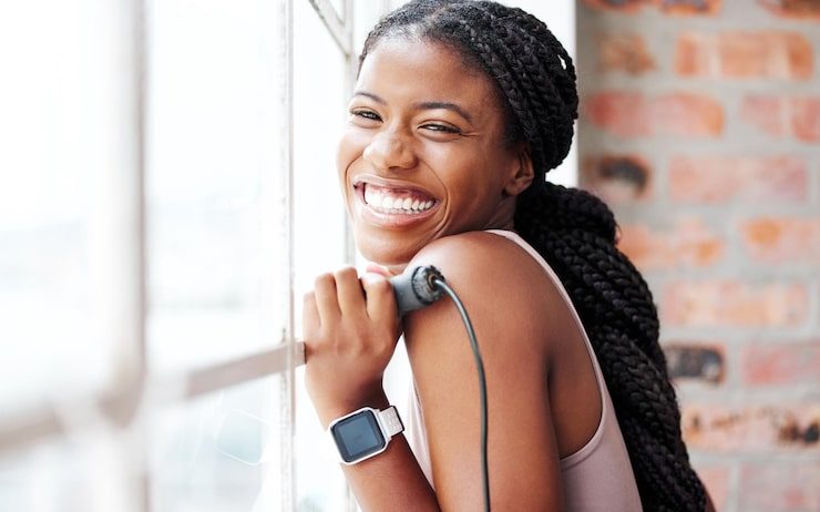 A patient smiling during a wellness check at Nourish Health Life